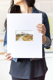 woman holding a landscape watercolor painting on a large mat