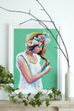 Green painting woman braiding hair with flower crown Flavia Bennard