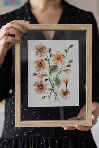 woman holding an orange watercolor flowers bouquet on a glass frame Flavia Bennard