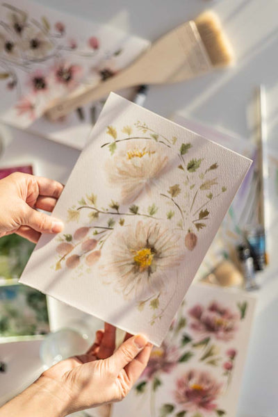 hands holding a beautiful soft watercolor flowers painting Flavia Bennard