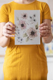 woman holding a loose watercolor flowers watercolor bouquet - Flavia Bennard