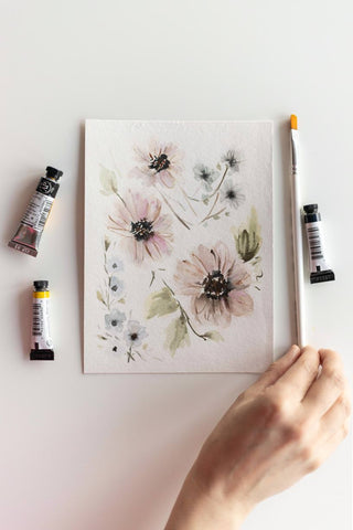 loose watercolor flowers painting next to paint tubes and brush Flavia Bennard