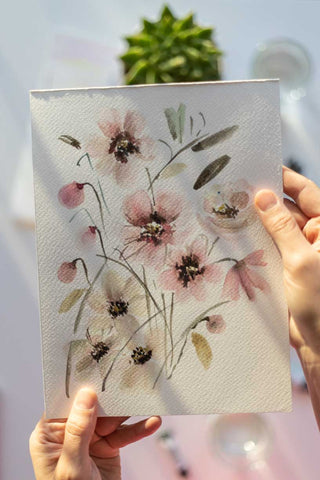 hands holding a watercolor flowers painting Flavia Bennard