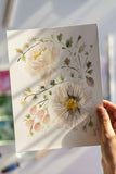 hand holding a loose white watercolor flowers painting Flavia Bennard